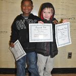 Ben with Silas and their awards