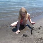 Lexi makes a sand castle